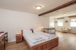 a bedroom with a large bed with white sheets at Luxuriöse Sandstein Villa - 320 qm - 7 Räume in Dresden +65 photos