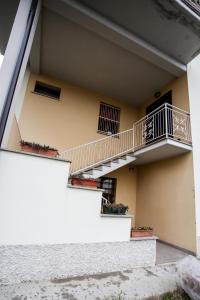a building with stairs and potted plants at Guest House Sassuolo 2 in Sassuolo