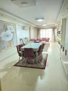 a dining room with a table and chairs at Vera home in Kafr al Ishārah