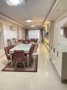 a living room with a table and chairs and a couch at Vera home in Kafr al Ishārah