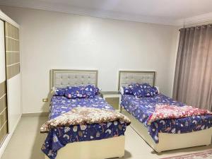 a bedroom with two beds in a room at Vera home in Kafr al Ishārah