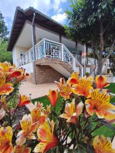a view of the house from the garden with flowers at Don Bazilio Brace in Leptokarya