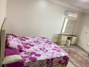 a bedroom with a bed and a dresser and a mirror at Vera home in Kafr al Ishārah +2 photos