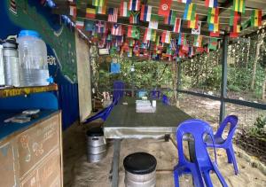 a table and chairs in a classroom with colorful flags at One Ocean Nature Conservation Centre in Kota Belud +56 photos