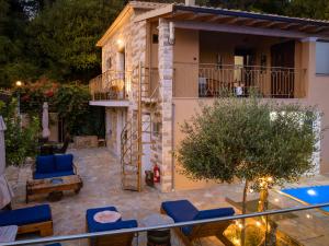 a view of a villa with a swimming pool at Olive & Wave Cottage in Karousádes