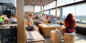 a group of people sitting in a restaurant at Lapland Hotels Arena in Tampere