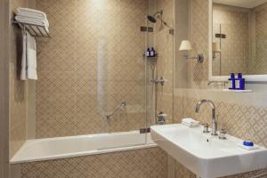 a bathroom with a sink and a shower at The Phoenicia Malta - The Leading Hotels of the World in Valletta