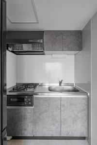 a kitchen with a sink and a stove at Astage Chitose Suehiro 103 in Chitose +40 photos