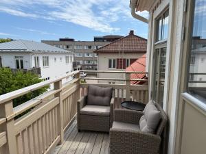 a balcony with two chairs and a table at Stava Mosters in Mariehamn