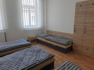 a bedroom with two beds and a dresser at Ubytování Klicperova in Chlumec nad Cidlinou +5 photos
