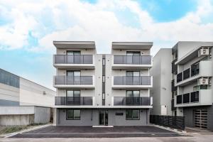 an apartment building with balconies in a parking lot at Astage Chitose Suehiro 103 in Chitose