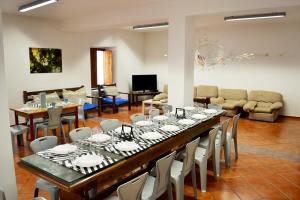 a large dining room with a long table and chairs at Ostello del Parco di Monte Cucco in Costacciaro
