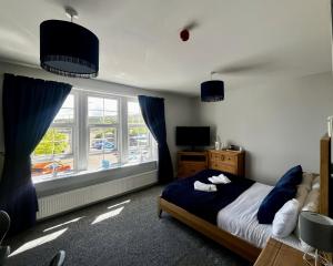 a bedroom with a bed and a large window at The Harbour Hotel in Greenock