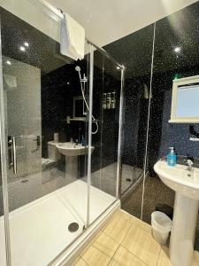 a bathroom with a shower and a sink at The Harbour Hotel in Greenock +14 photos