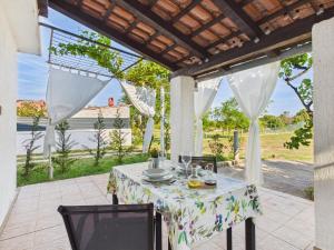 a table with a white table cloth on a patio at Apartments Jan in Banjole