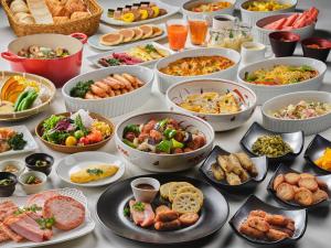 a table topped with lots of different types of food at La Vista Minami Aso Grand opening October 2nd 2026 in Minami Aso