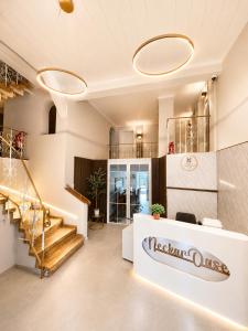 a lobby of a restaurant with a sign on the wall at Hotel NeckarOase in Lauffen am Neckar