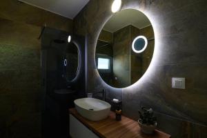 a bathroom with a sink and a mirror at Cleopatra Residence in Perea