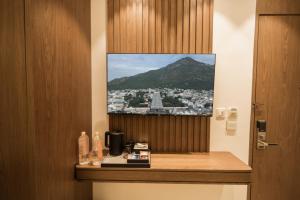 a wall with a picture of a view of a mountain at Sawariya Hotels in Tiruvannāmalai