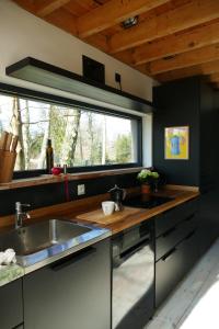 a kitchen with a sink and a large window at Bosco Due in Łagów