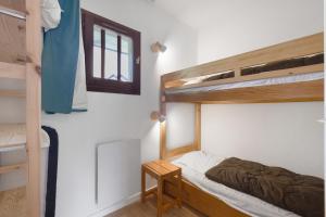 a bedroom with two bunk beds and a table at Les Cimes - La Canopée in Gresse-en-Vercors