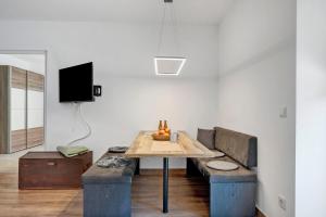 a living room with a table and a couch at Richard´s Home Auer in Auer