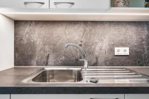 a stainless steel sink in a kitchen at Richard´s Home Auer in Auer +78 photos