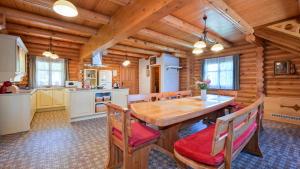 a kitchen with a wooden table in a log cabin at Villa Pine Log by Villas Guide in Dubrovčan