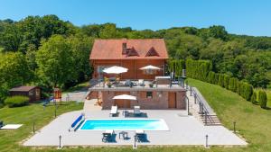 an aerial view of a house with a swimming pool at Villa Pine Log by Villas Guide in Dubrovčan