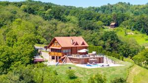 an aerial view of a house with a swimming pool at Villa Pine Log by Villas Guide in Dubrovčan