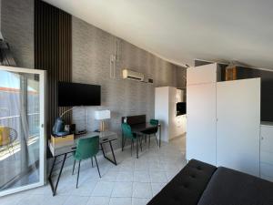 a living room with a couch and a table with chairs at Apartments Vodice in Vodice