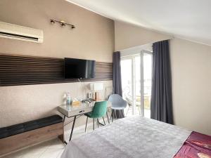a bedroom with a bed and a desk with a computer at Apartments Vodice in Vodice