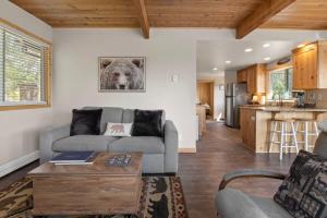 a living room with a couch and a dog picture on the wall at Stone Cliff Cottage in Golden