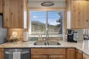 a kitchen with a sink and a window at Stone Cliff Cottage in Golden