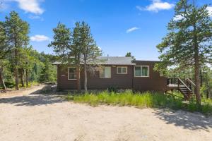 a home in the woods with a lot of trees at Stone Cliff Cottage in Golden +28 photos