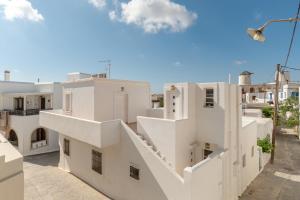 a view of a white building with stairs at Vivlos Stays - Ageri in Vívlos