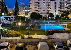 a view of a swimming pool at night at Apartamento Davasa in Armação de Pêra