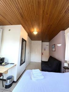 a bedroom with a bed with a wooden ceiling at Les Loges du Vercors in Vizille