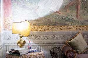 a room with a table with a lamp and books at Hotel Burchianti in Florence