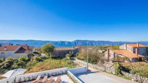 a view of a town with mountains in the background at Villa Isabella by Villas Guide in Malinska