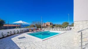 a swimming pool in the middle of a yard at Villa Isabella by Villas Guide in Malinska