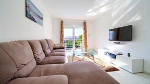a living room with a couch and a tv at Villa Isabella by Villas Guide in Malinska