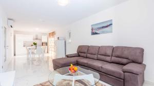 a living room with a couch and a table at Villa Isabella by Villas Guide in Malinska