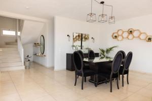 a dining room with a black table and black chairs at Ionion exclusive villa in Syvota