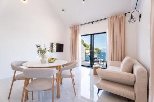a dining room with a table and chairs and a window at Azure Adriatic in Prožura