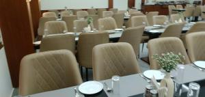 a room full of tables and chairs with tables and chairsktop at Hotel Harsh Vilas-Near Tajmahal Agra in Agra