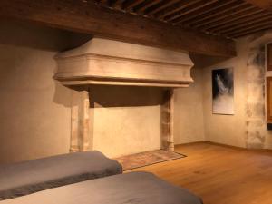 a room with a column and a bed in it at La Maison Forte in Courtenay
