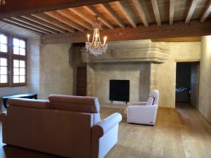 a living room with two couches and a fireplace at La Maison Forte in Courtenay