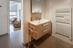 a bathroom with a sink and a mirror at Chambres hôtes Le Champ Des Oiseaux in Rochechouart