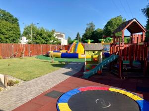 a park with a playground with a slide at Třebovický mlýn in Ostrava